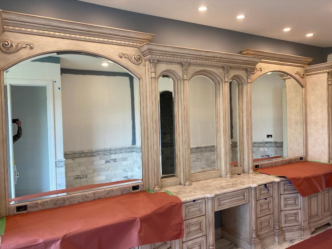 A bathroom with a lot of mirrors and a vanity