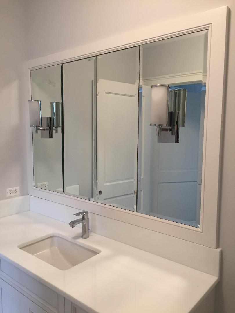 A bathroom with two sinks and a large mirror.
