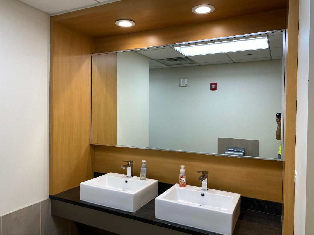 A bathroom with two sinks and a large mirror.