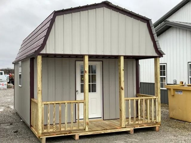 A small shed with a porch and a door.