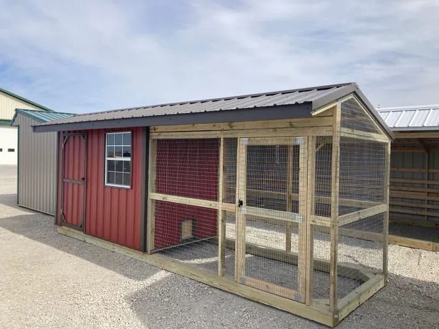 A red shed with a chicken coop attached to it.