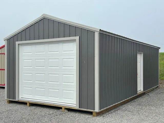 A gray and white garage with a white garage door.