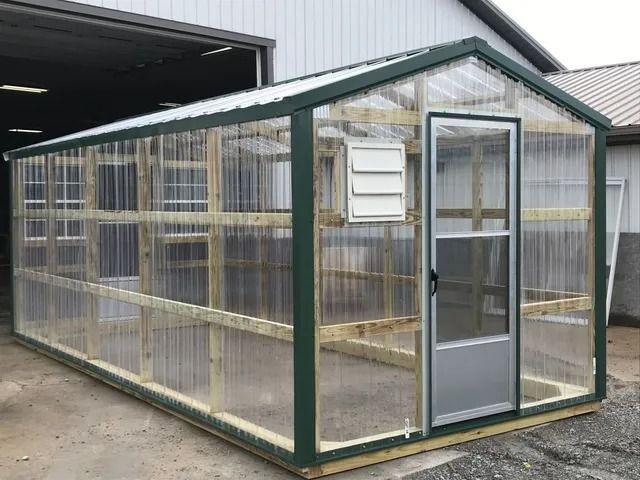 A greenhouse is being built in front of a building.