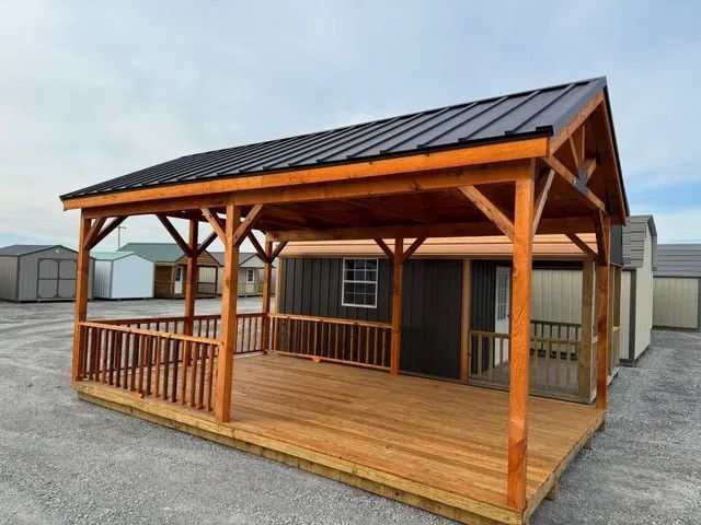 A shed with a wooden deck and a metal roof