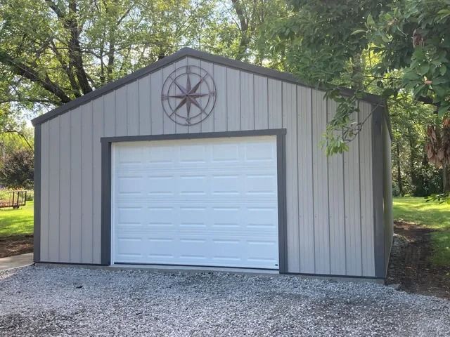 A garage with a white door and a compass on it