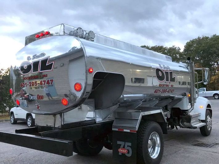 A tanker truck is parked in a parking lot.