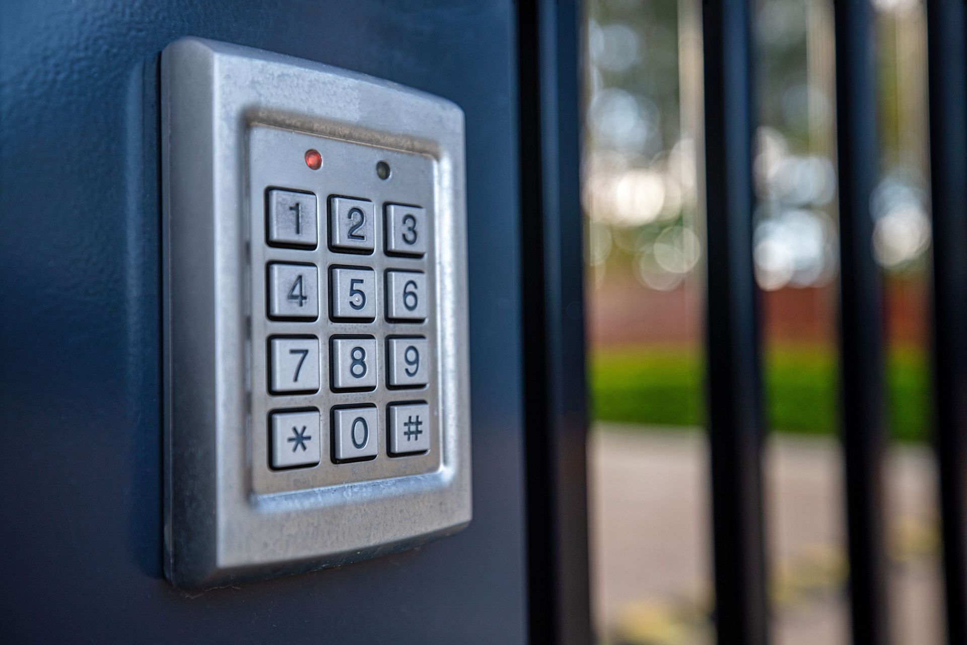 Silver keypad on black gate post, used to enter security code.