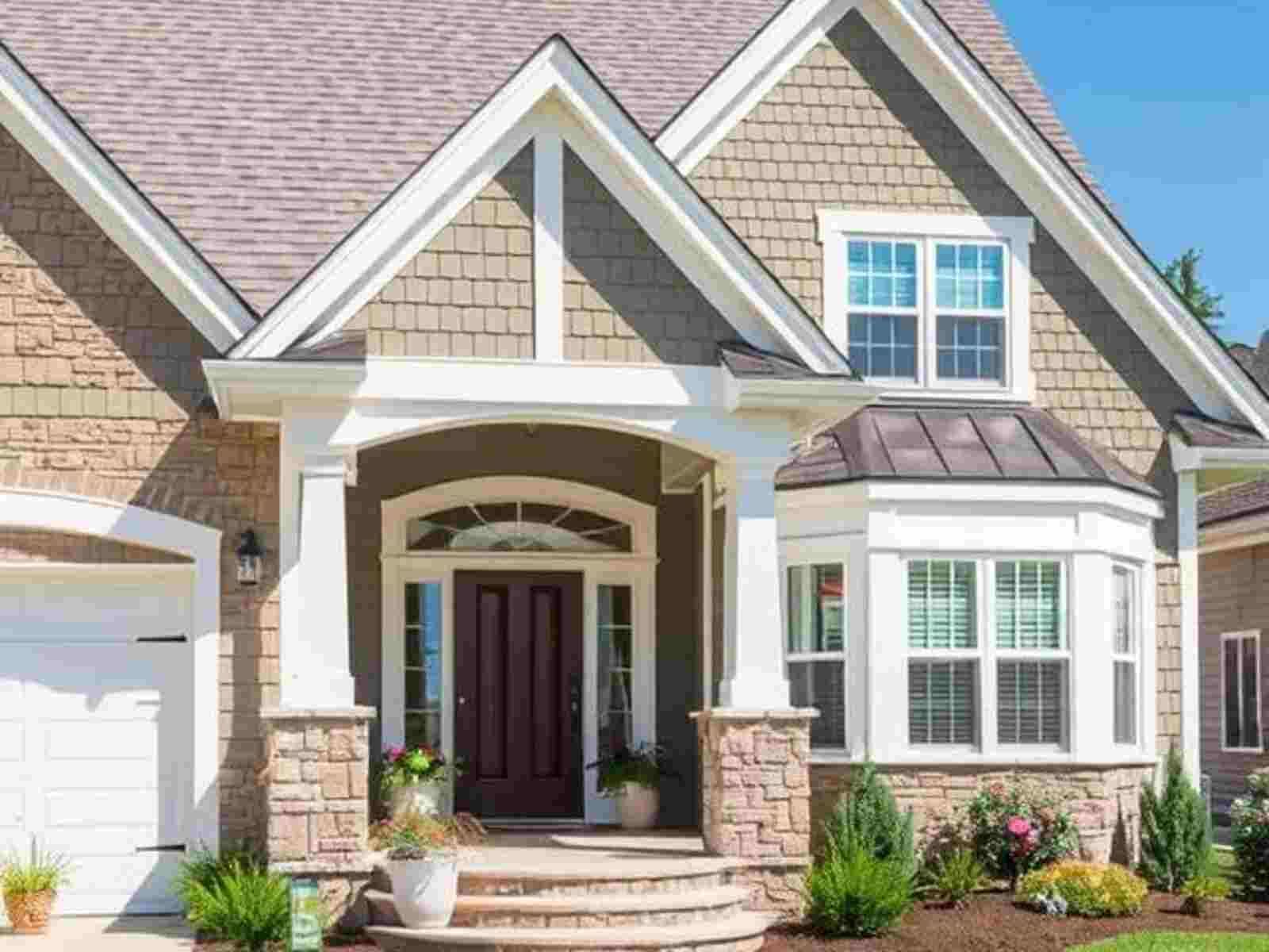 A large house with a large porch and a large garage.