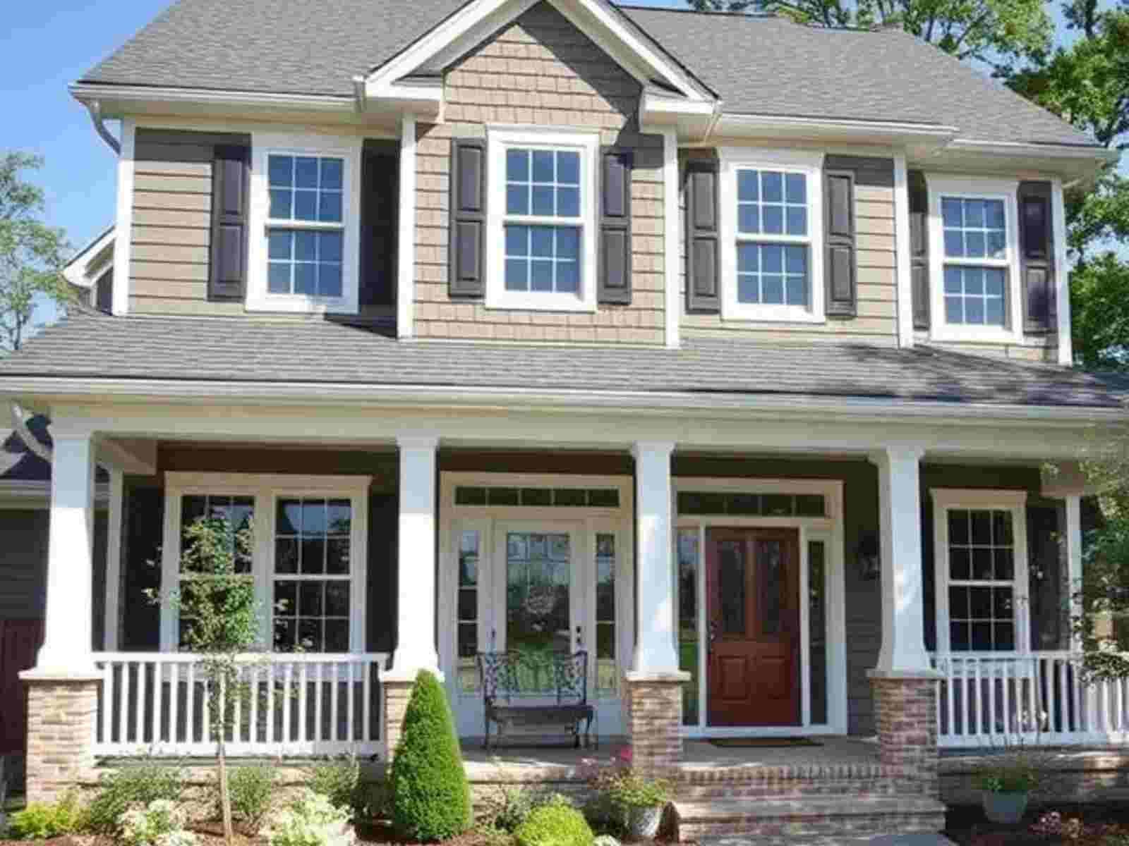 A house with a large porch and lots of windows