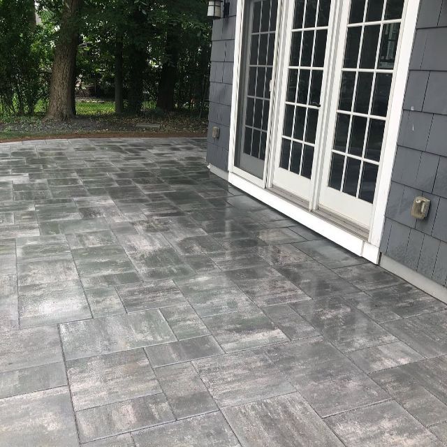 A patio with sliding glass doors leading to a house