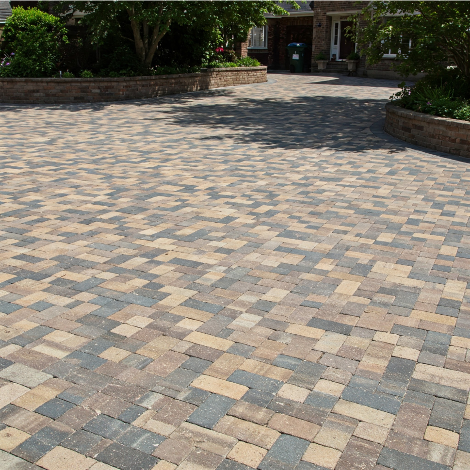 A brick driveway in front of a house
