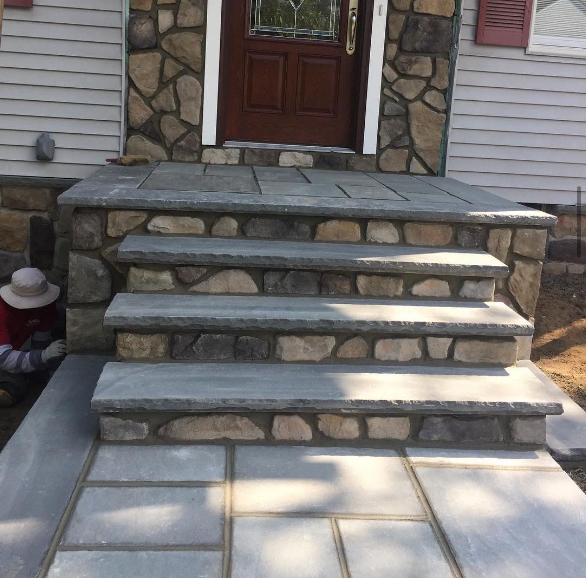 A set of stone steps leading up to the front door of a house