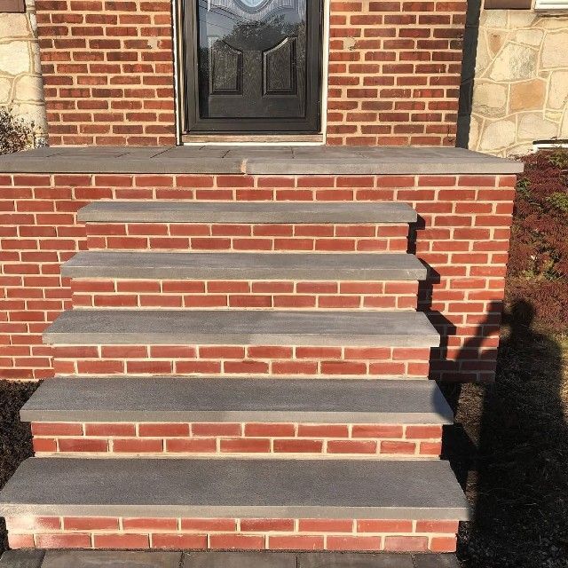 A set of brick steps leading up to a brick building