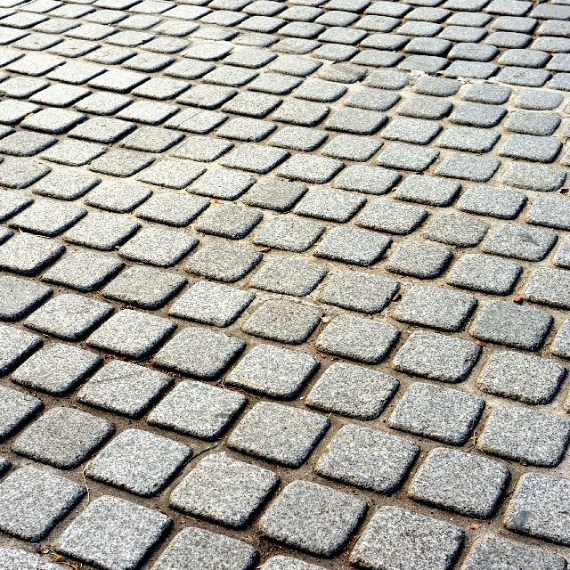 A close up of a brick pavement with a diagonal pattern