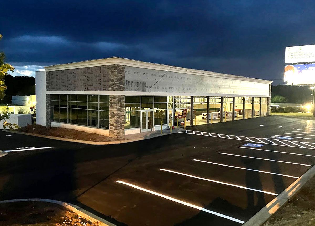 A large building with a newly paved parking lot