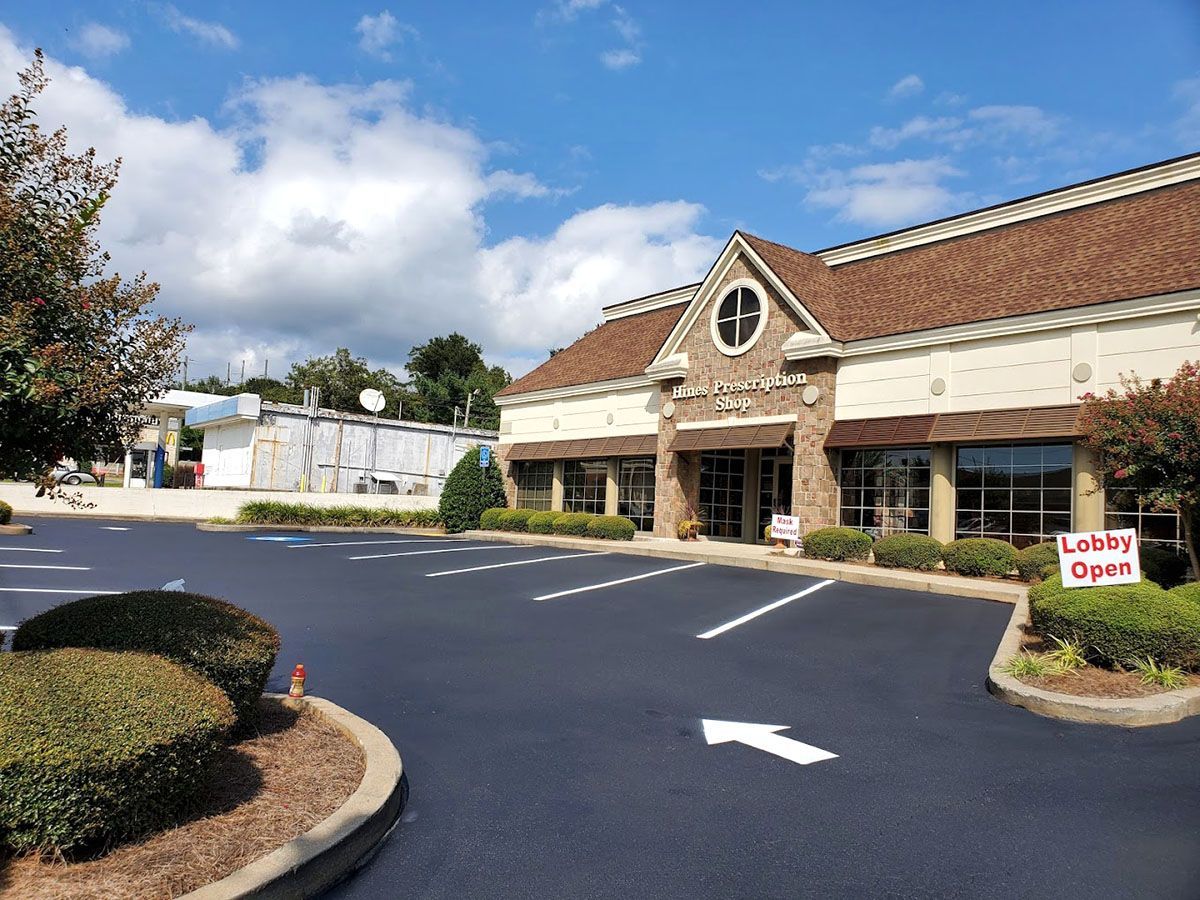 A large building with a newly paved parking lot in front of it