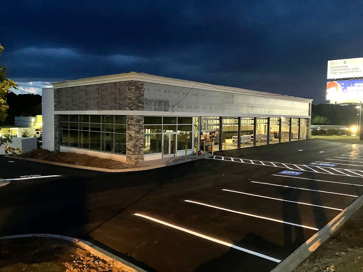 A large building with a newly paved parking lot