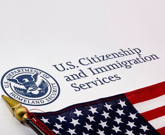 A u.s. citizenship and immigration services form with an american flag
