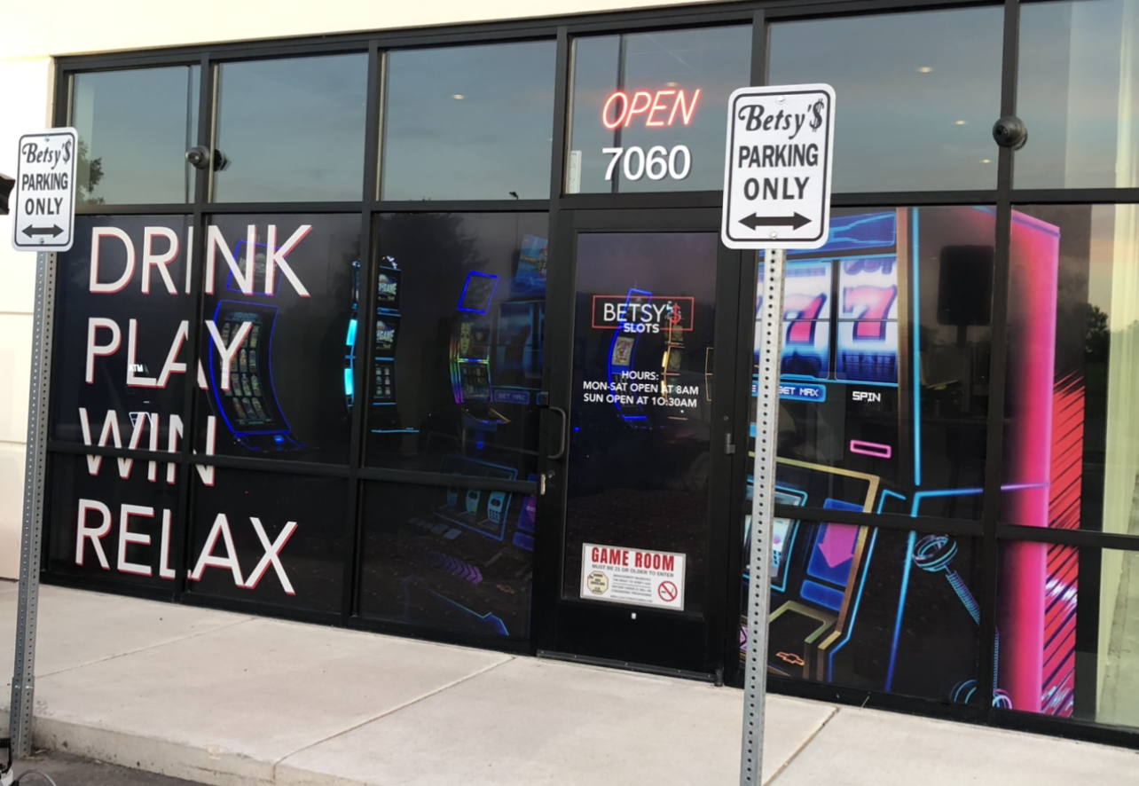 Gaming parlor storefront. Display windows with neon game art.