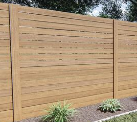 A modern horizontal slat wooden privacy fence stands in a landscaped garden with gravel and small green shrubs.