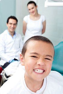 Kid visiting the dentist acting proud of his teeth