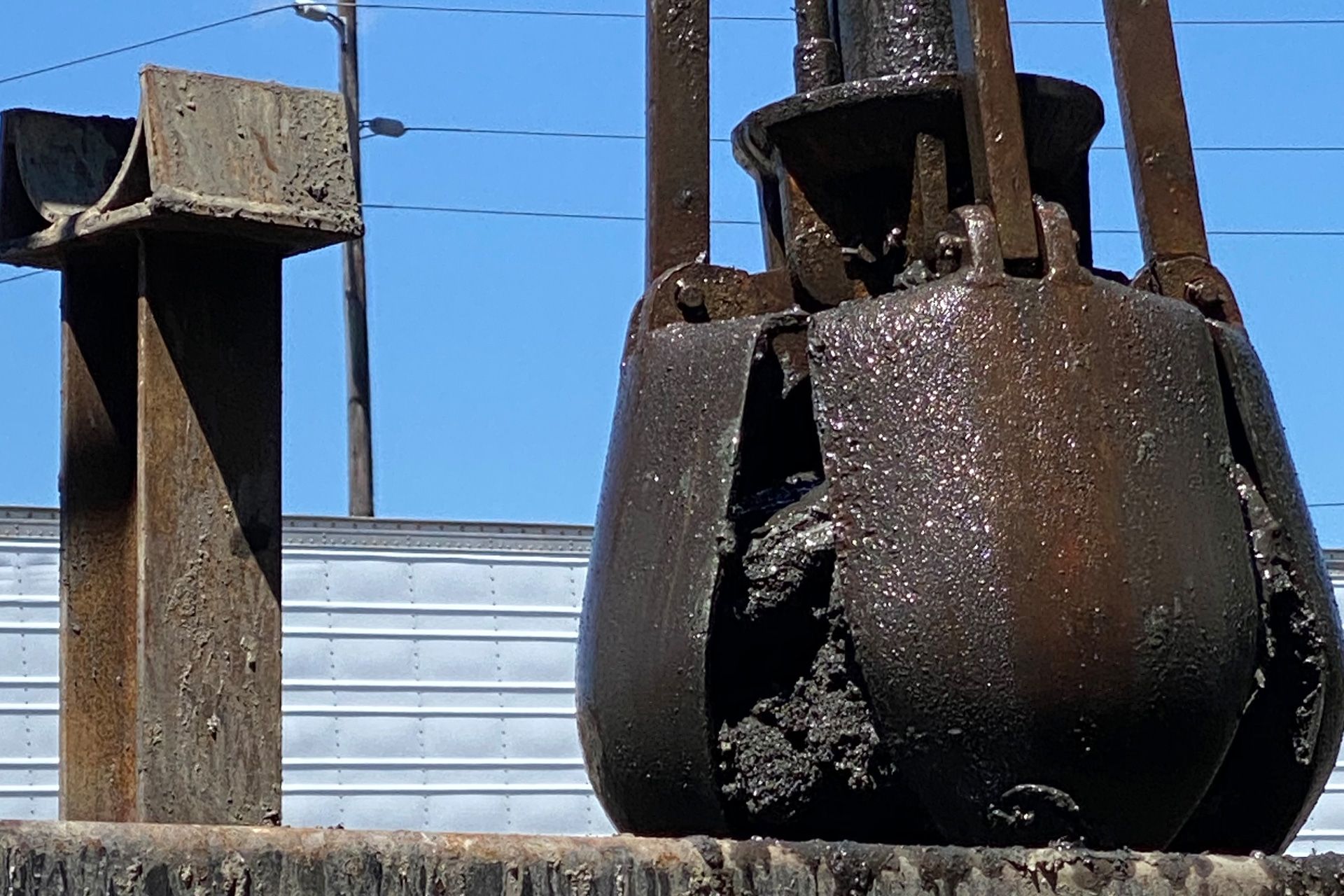 a large rusty object with a blue sky in the background