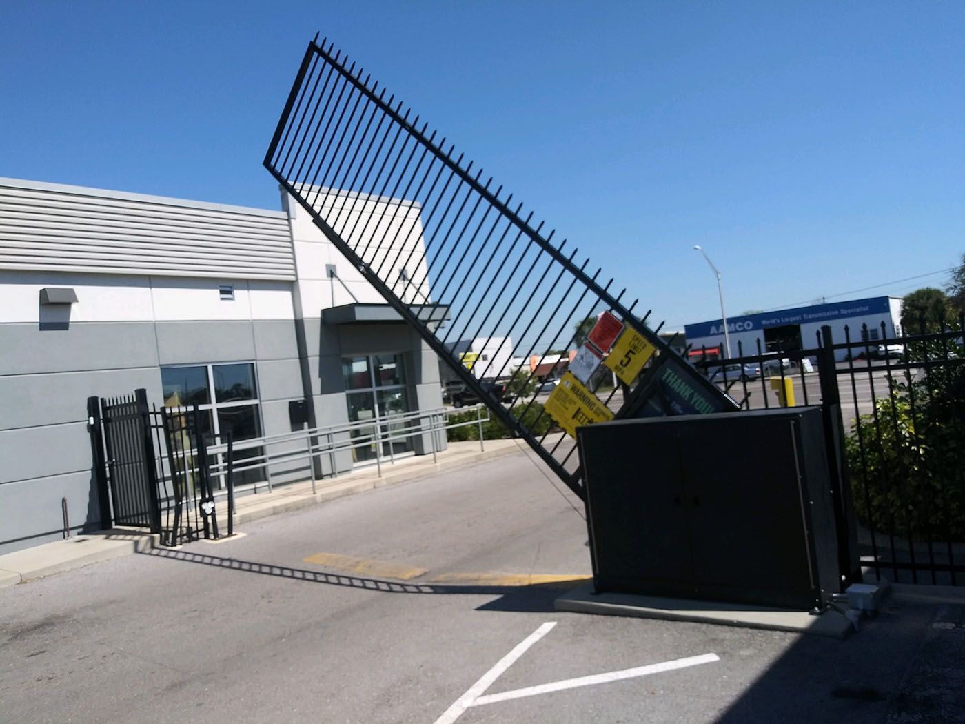 A fence that has a yellow sign on it that says