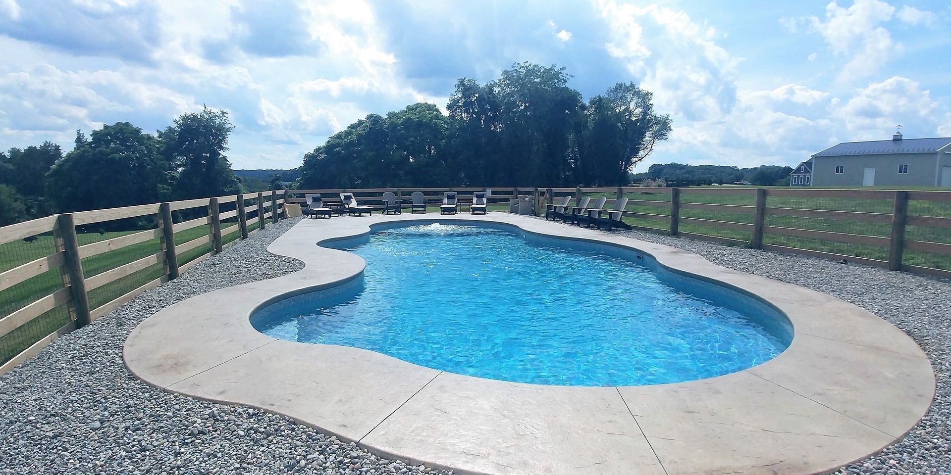 A large swimming pool with a fence around it