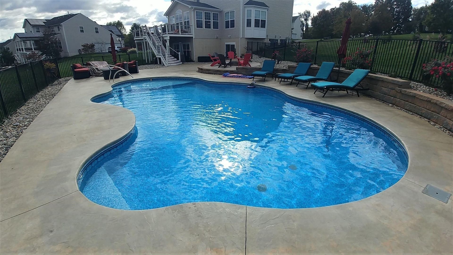 A large swimming pool in the backyard of a house