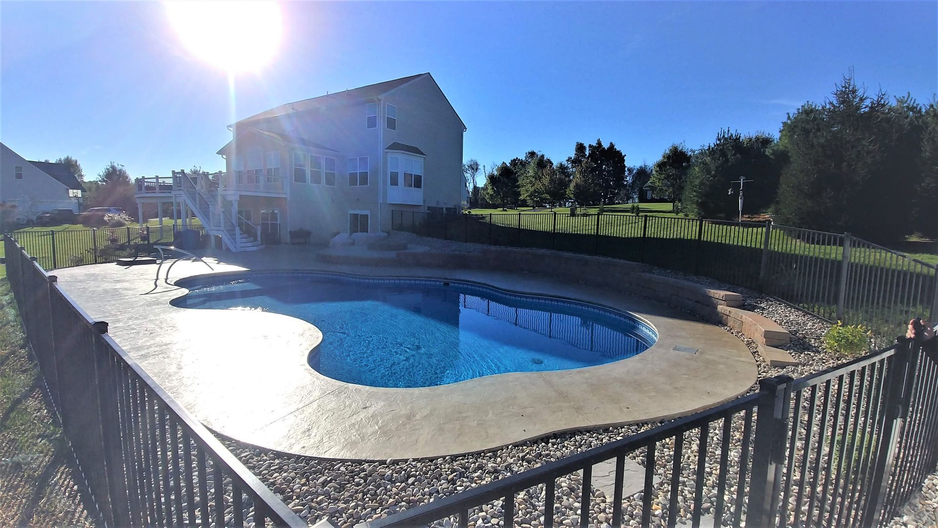 A large house with a large swimming pool in front of it