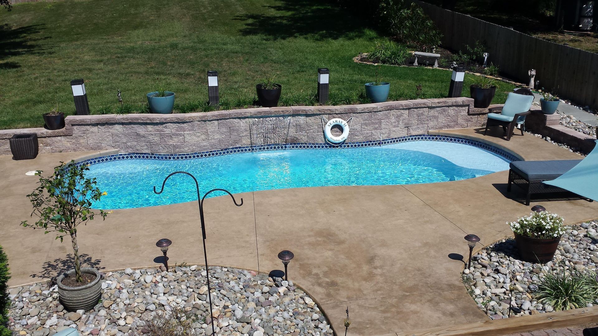 An aerial view of a swimming pool in a backyard