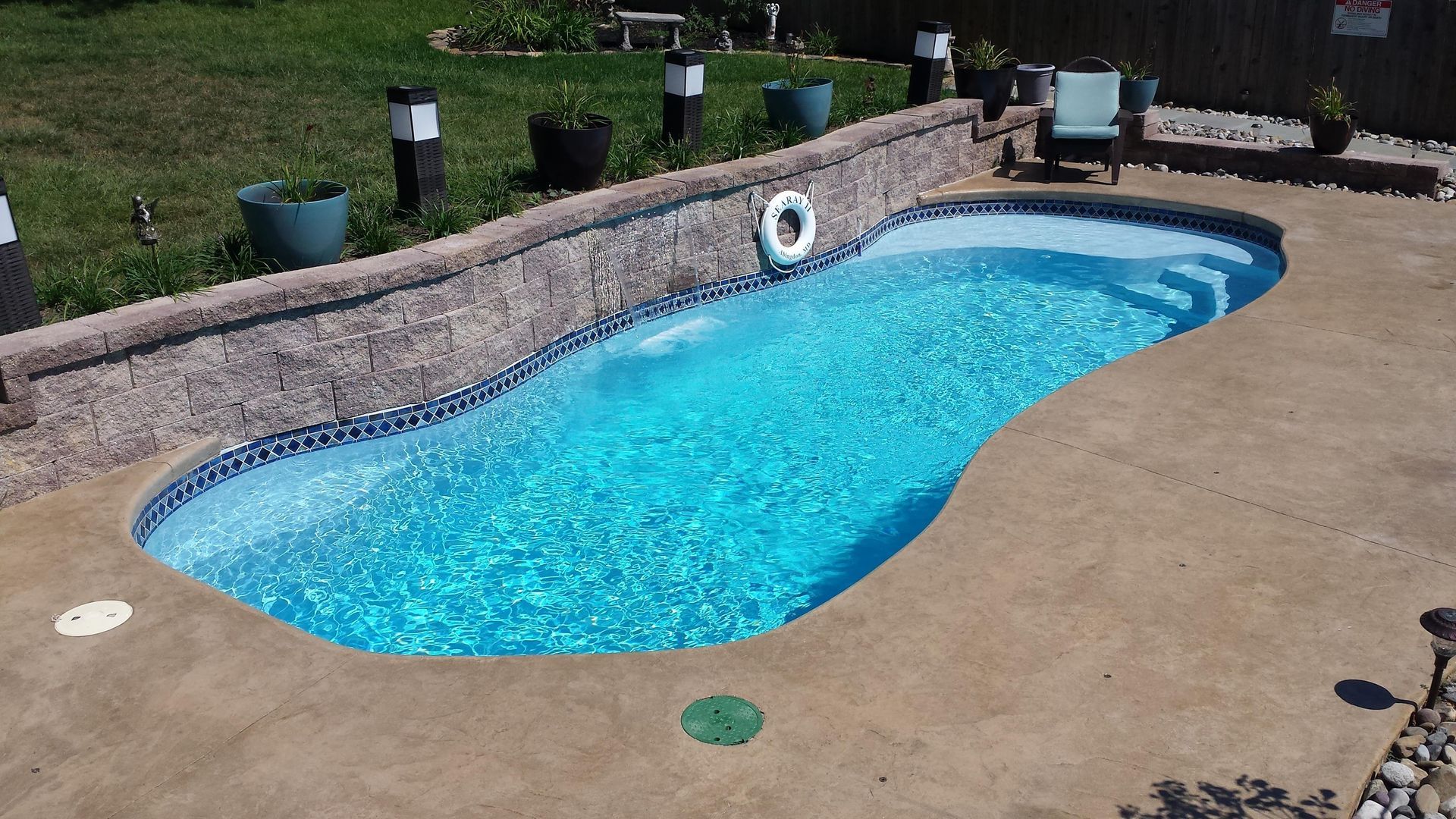 A swimming pool with a life preserver on the side of it