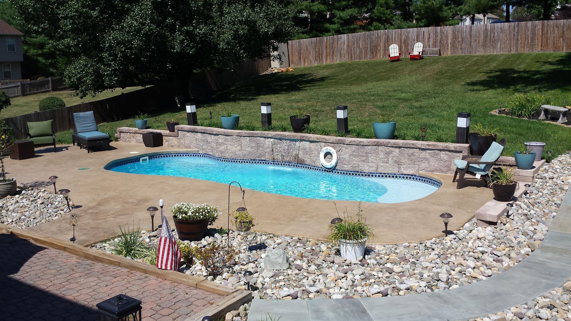 A large swimming pool with a life preserver in the middle of it