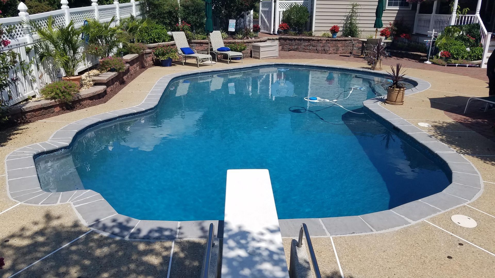 A large swimming pool with a diving board in the middle