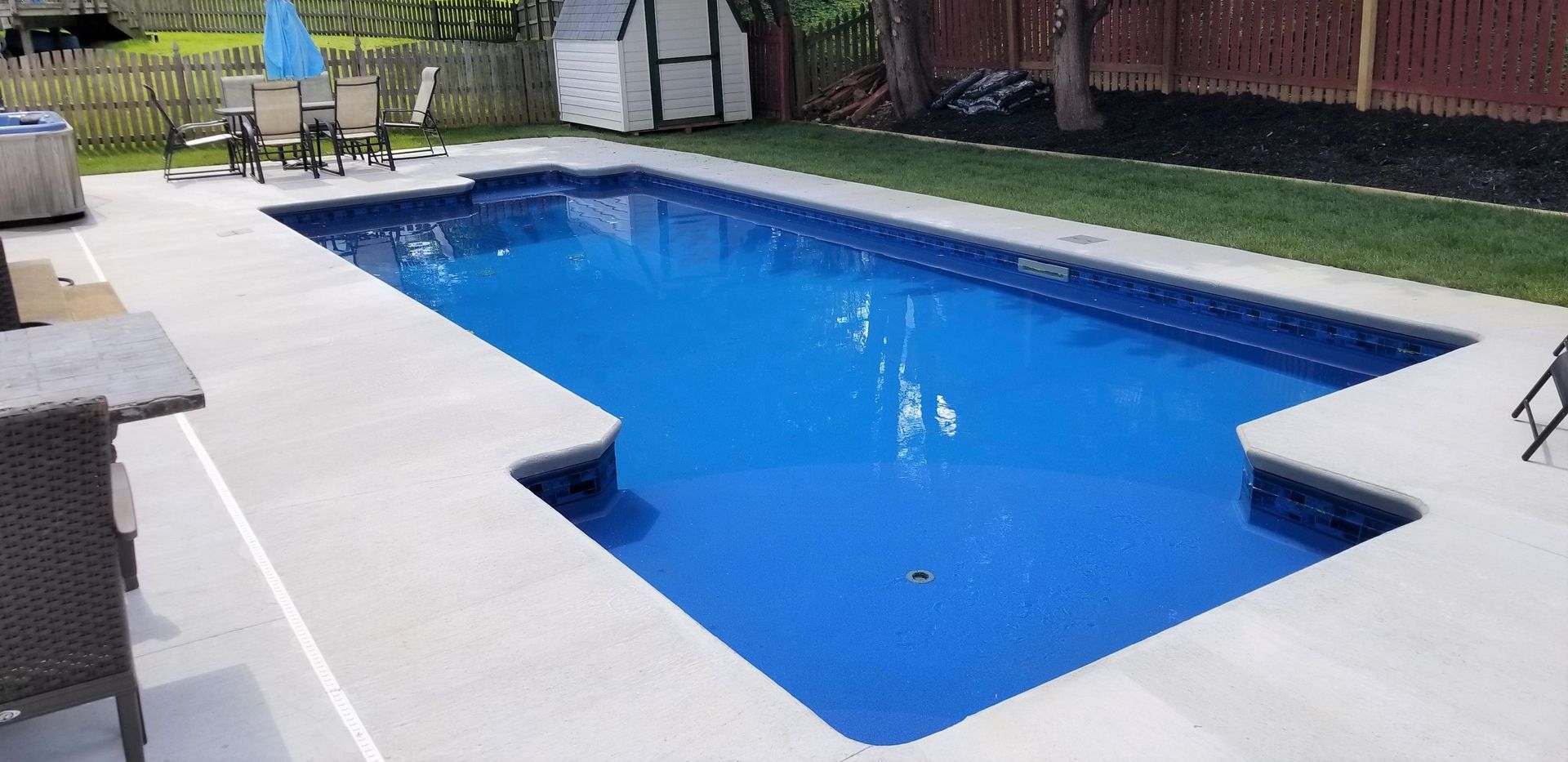 There is a large swimming pool in the backyard.