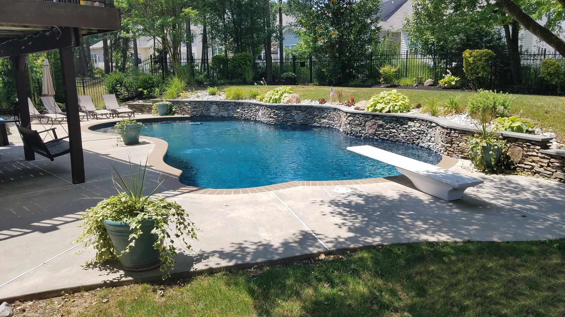 A large swimming pool in the backyard of a house