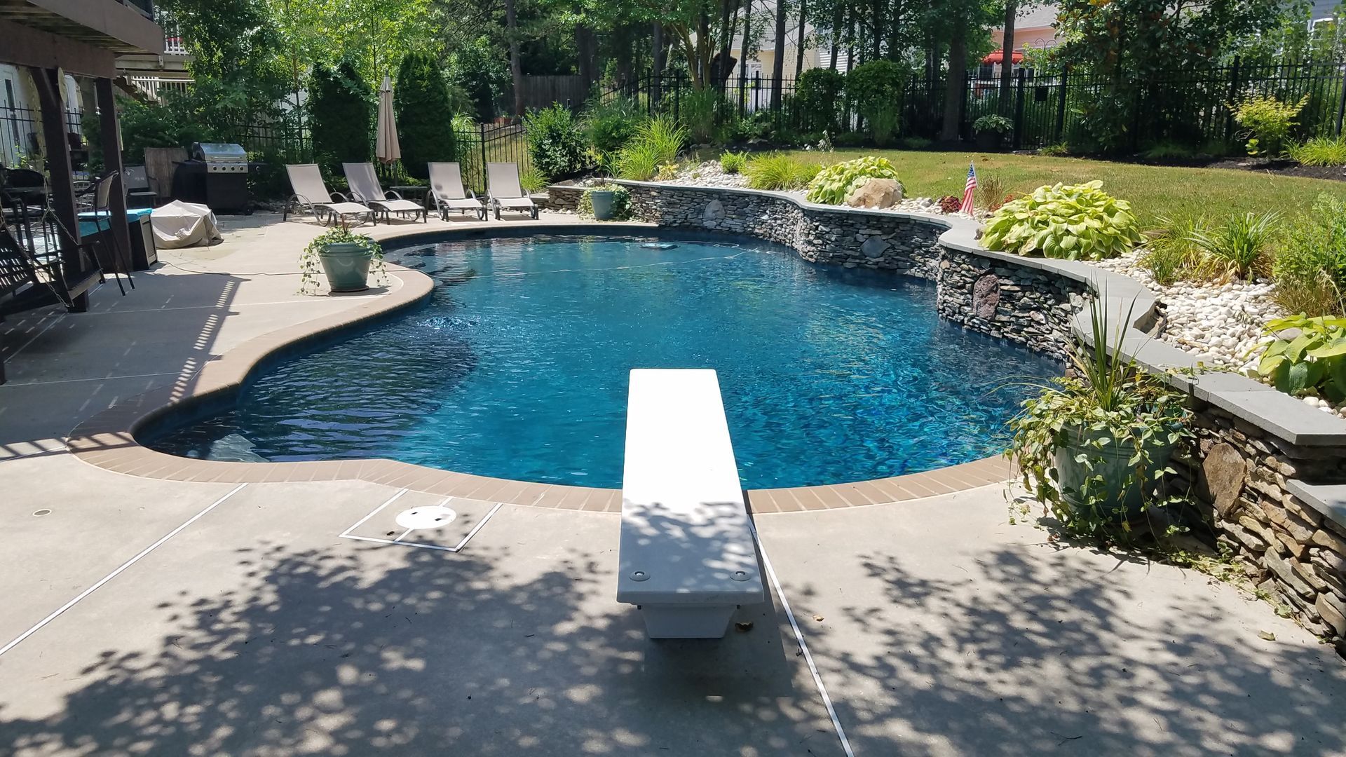 There is a diving board in the middle of the pool.
