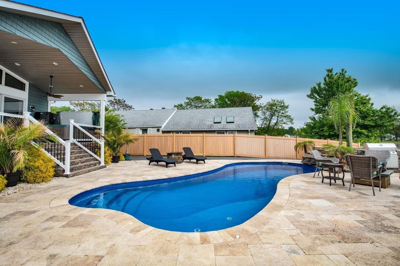 A large swimming pool in the backyard of a house