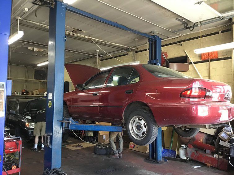Red car in auto repair shop