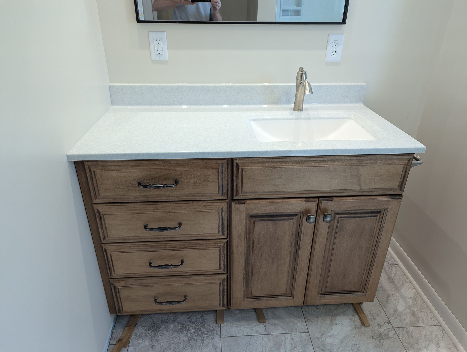 A bathroom vanity with a sink and a mirror