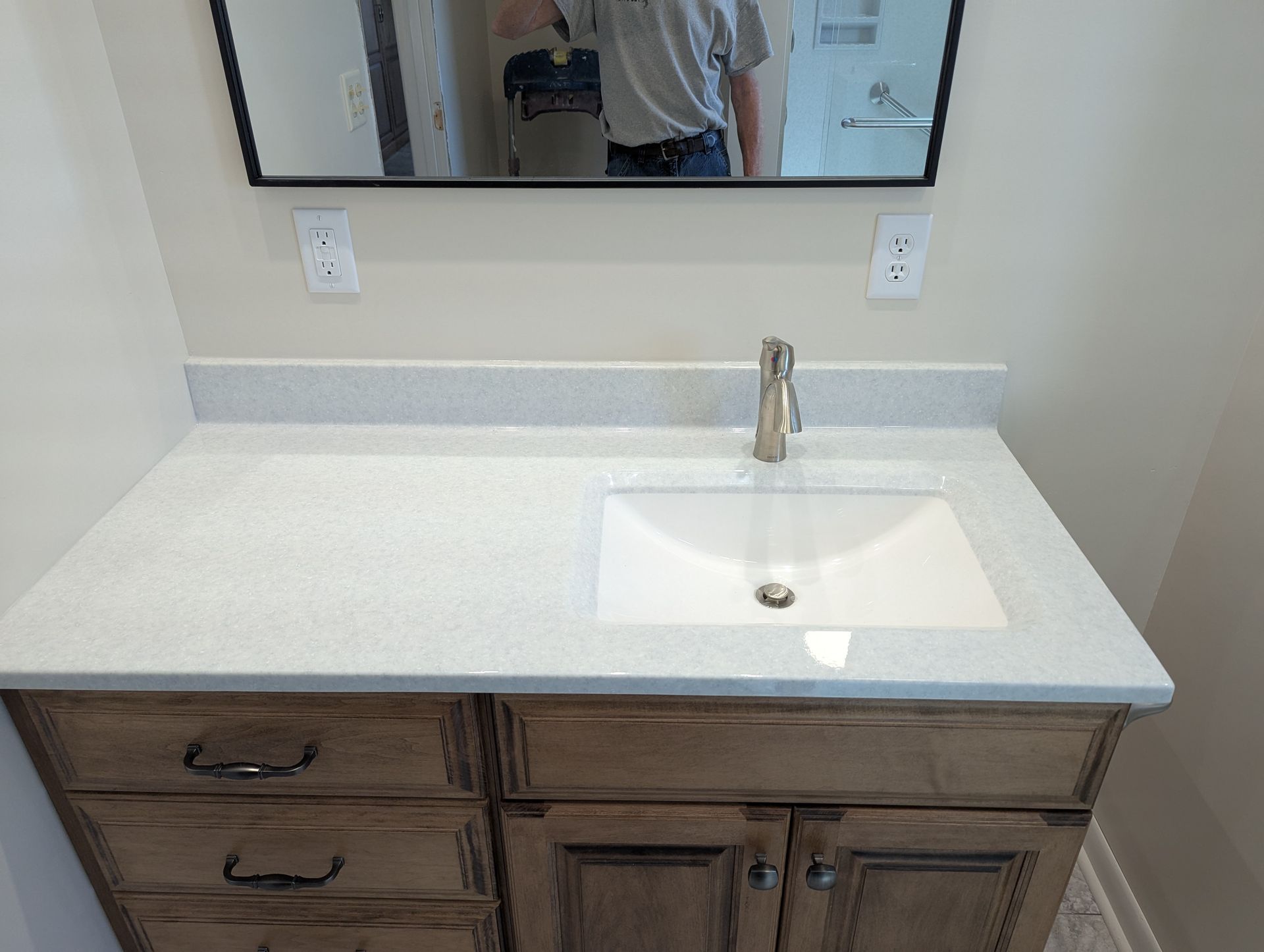 A bathroom vanity with a sink and a mirror.