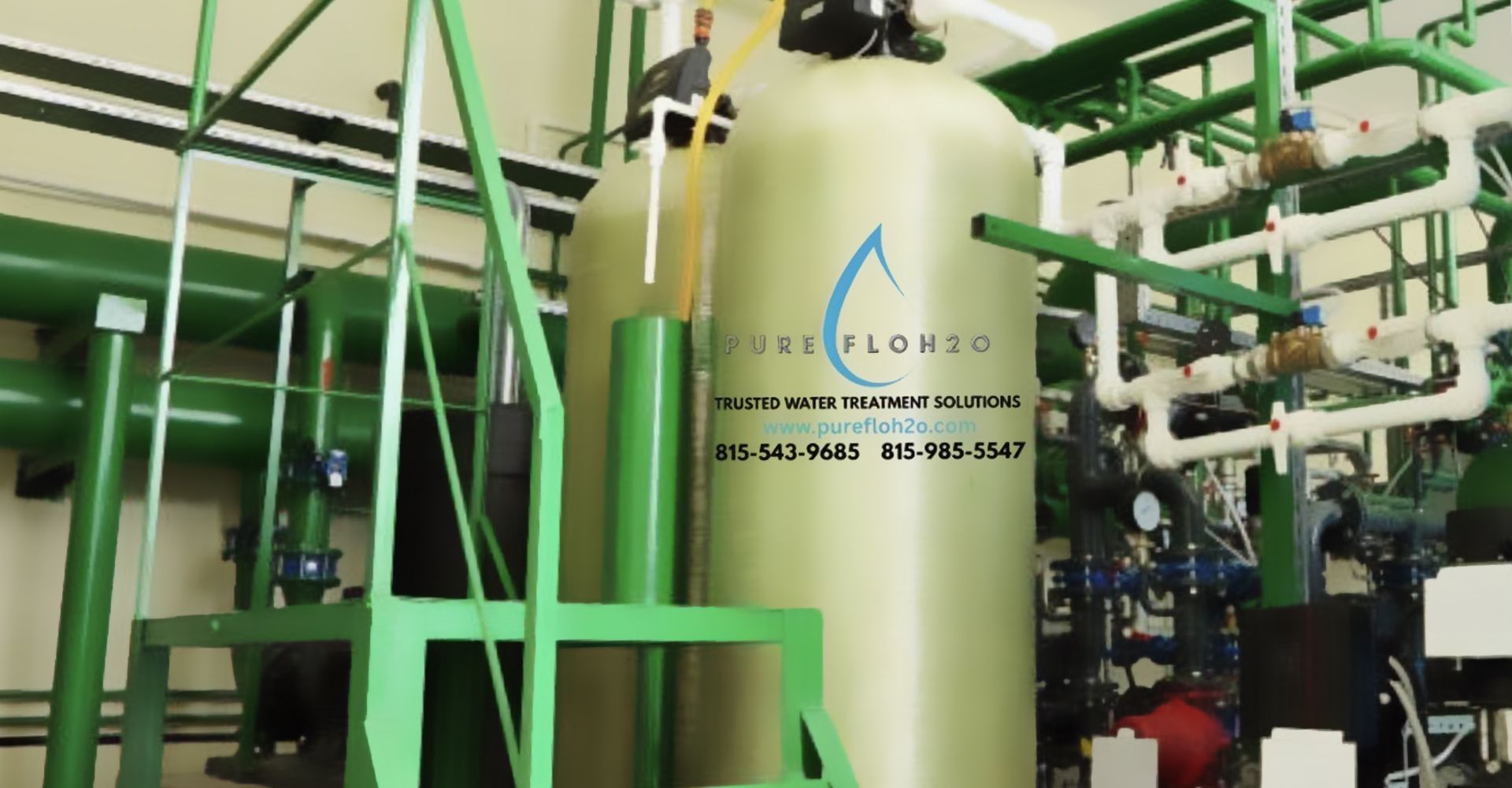 Chrome faucet with running water in a white bathroom sink. Soap dispenser and towel visible.