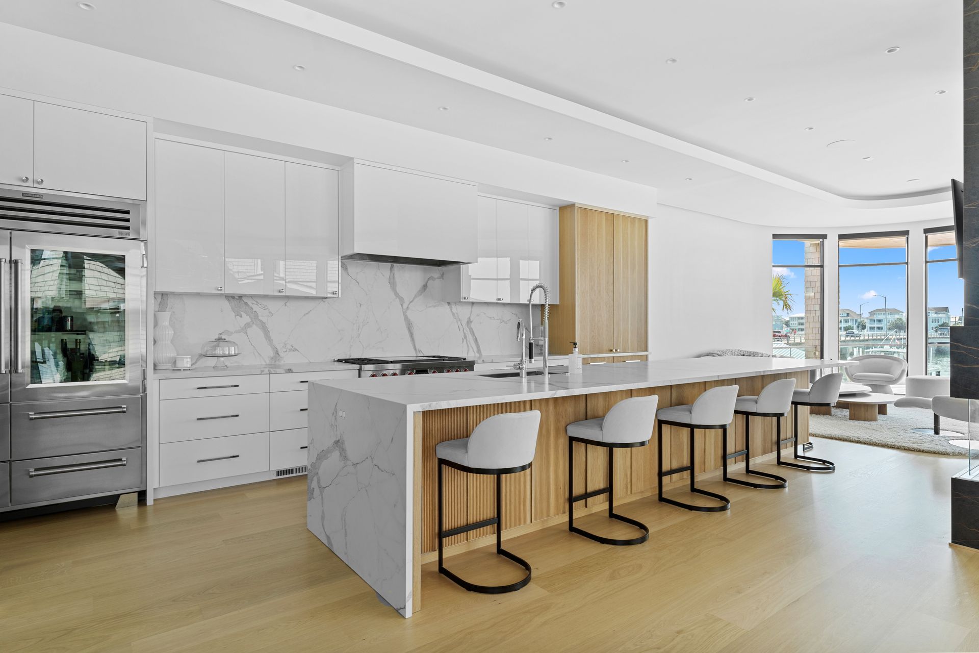 A living room with a couch, chair, coffee table and television.