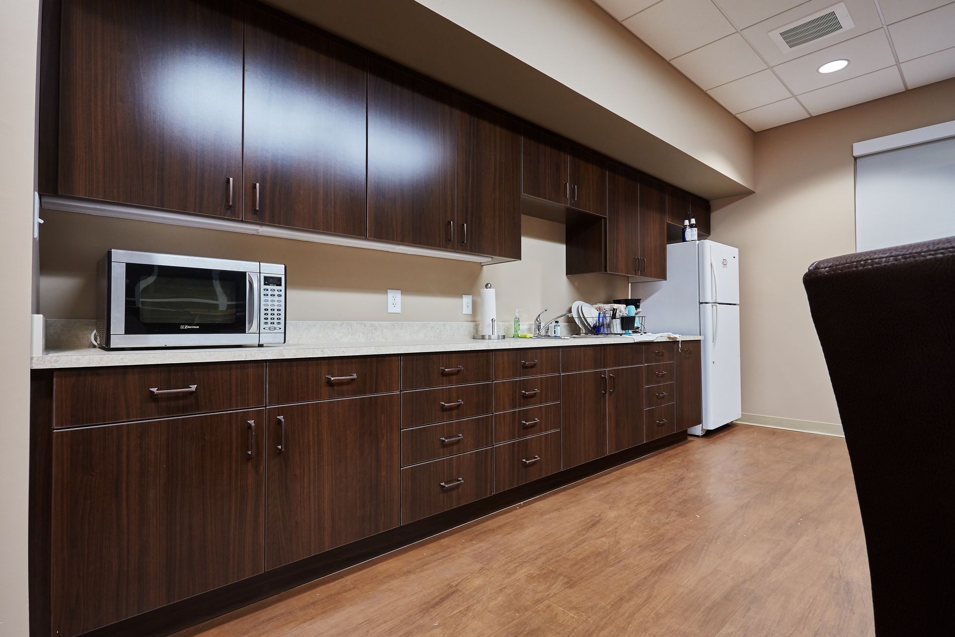 A kitchen with a microwave and a refrigerator