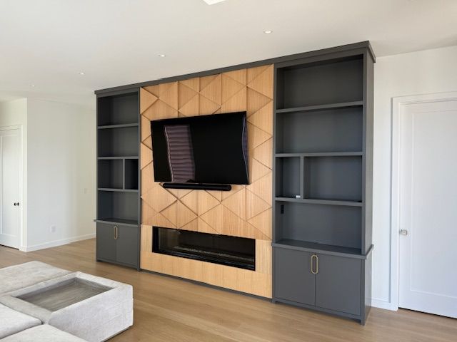A living room with a fireplace and a flat screen tv