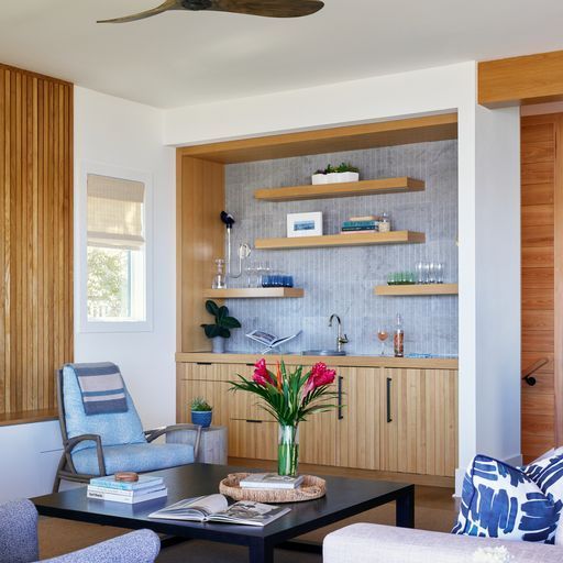 A bathroom with a sink, mirror and wooden floor.