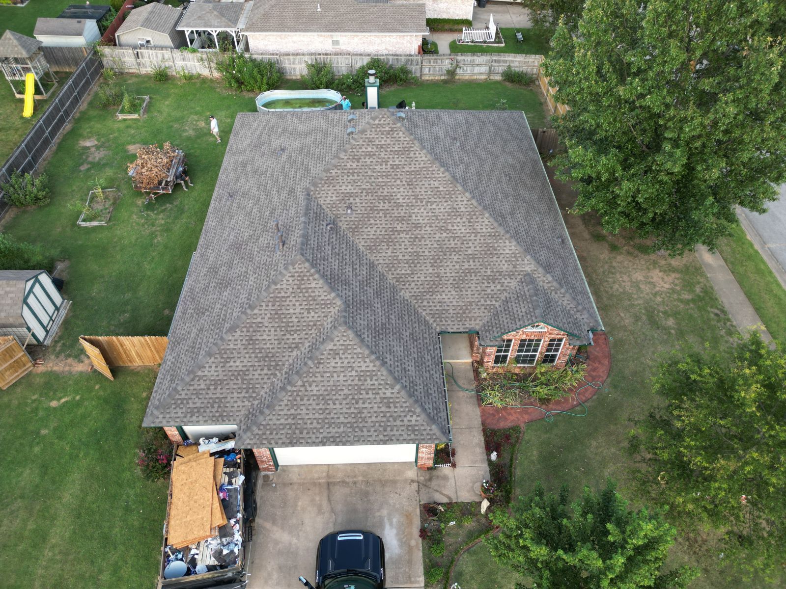 An aerial view of a house with a truck parked in front of it.