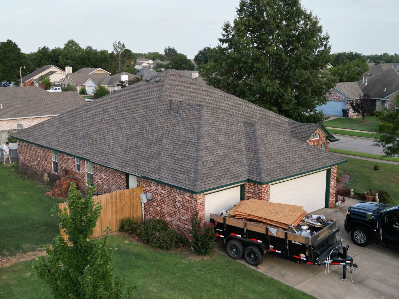 An aerial view of a house with a trailer parked in front of it.