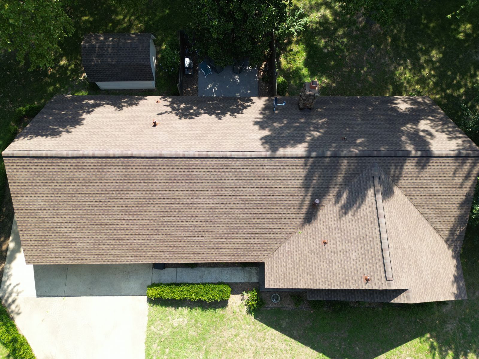 An aerial view of a house with a roof that is covered in shingles.