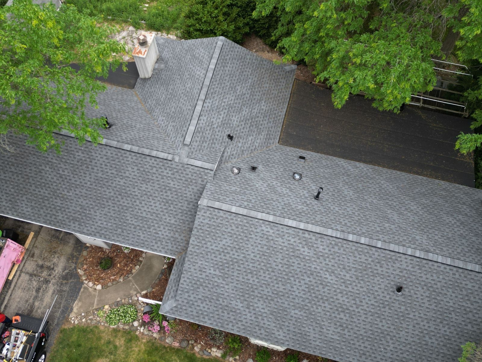 An aerial view of a house with a new roof.